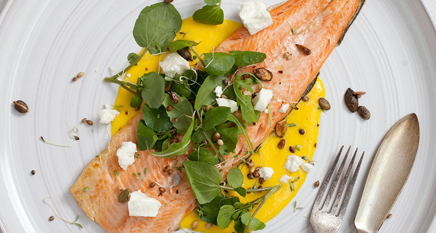 Grilled Trout with Wild Greens, Orange Zest Puree, Crunchy Seeds & Feta
