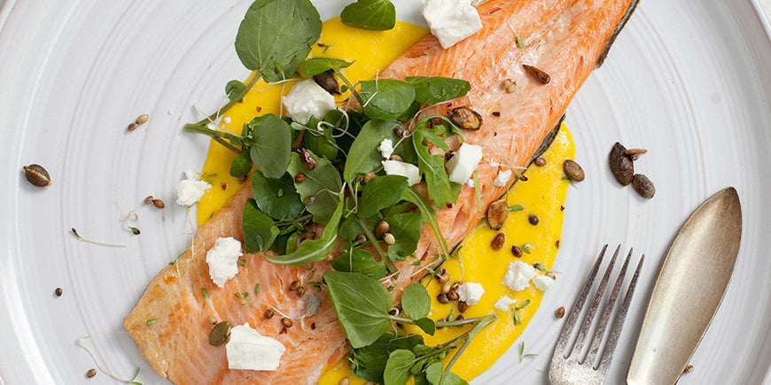 Grilled Trout with Wild Greens, Orange Zest Puree, Crunchy Seeds & Feta